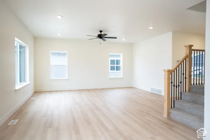 Family room with 9' ceiling and ceiling fan.