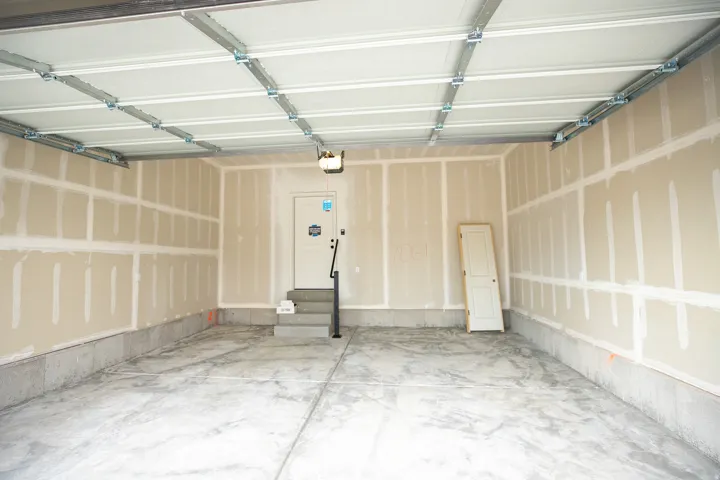Two car garage with taped finish.