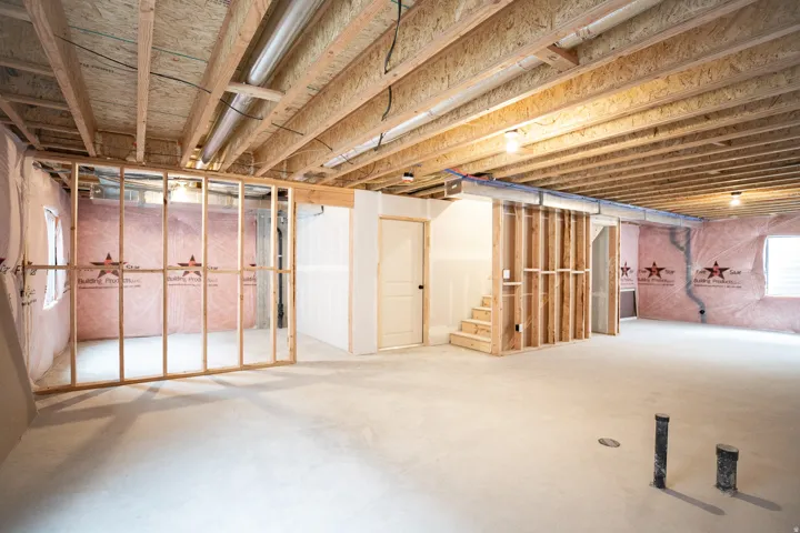 Unfinished basement with potential for large family/game room, full bathroom and two bedrooms.