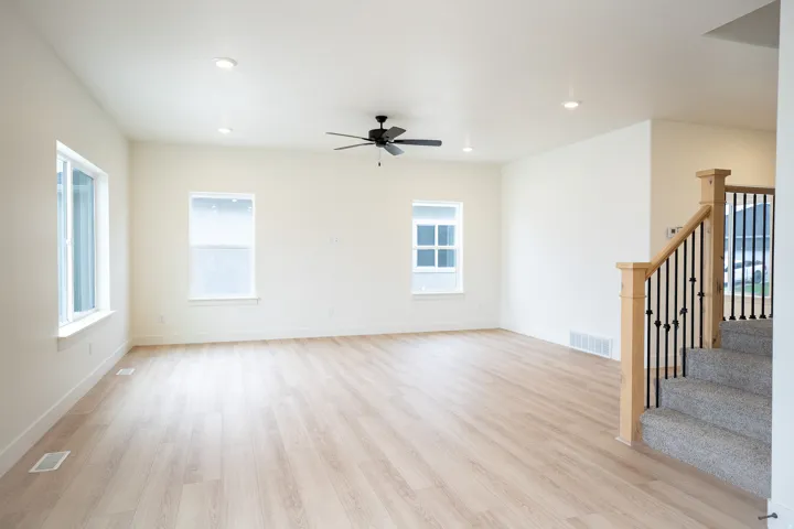Family room with 9' ceiling and ceiling fan.