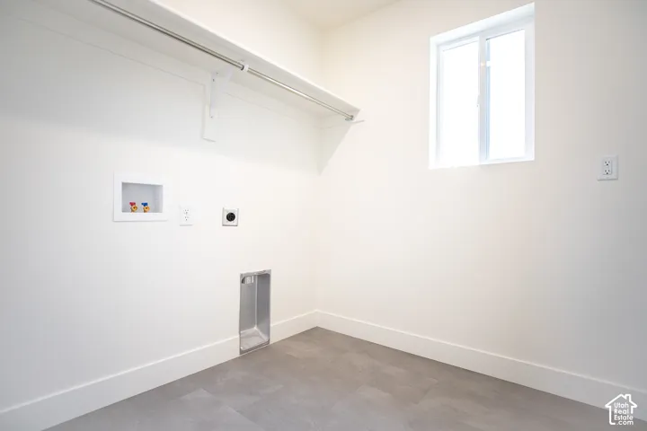 Full-size, dedicated laundry room with natural light and washer/dryer hookups.