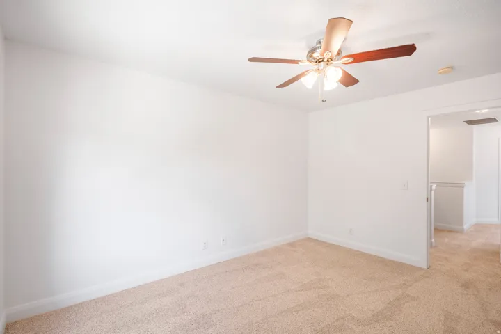 Recessed lighting, ceiling fan with light fixture, neutral carpet, white walls, and white trim