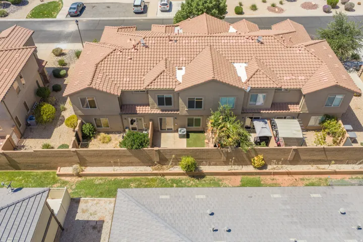 Terracotta tile roofing, stucco exterior, and private rear patio