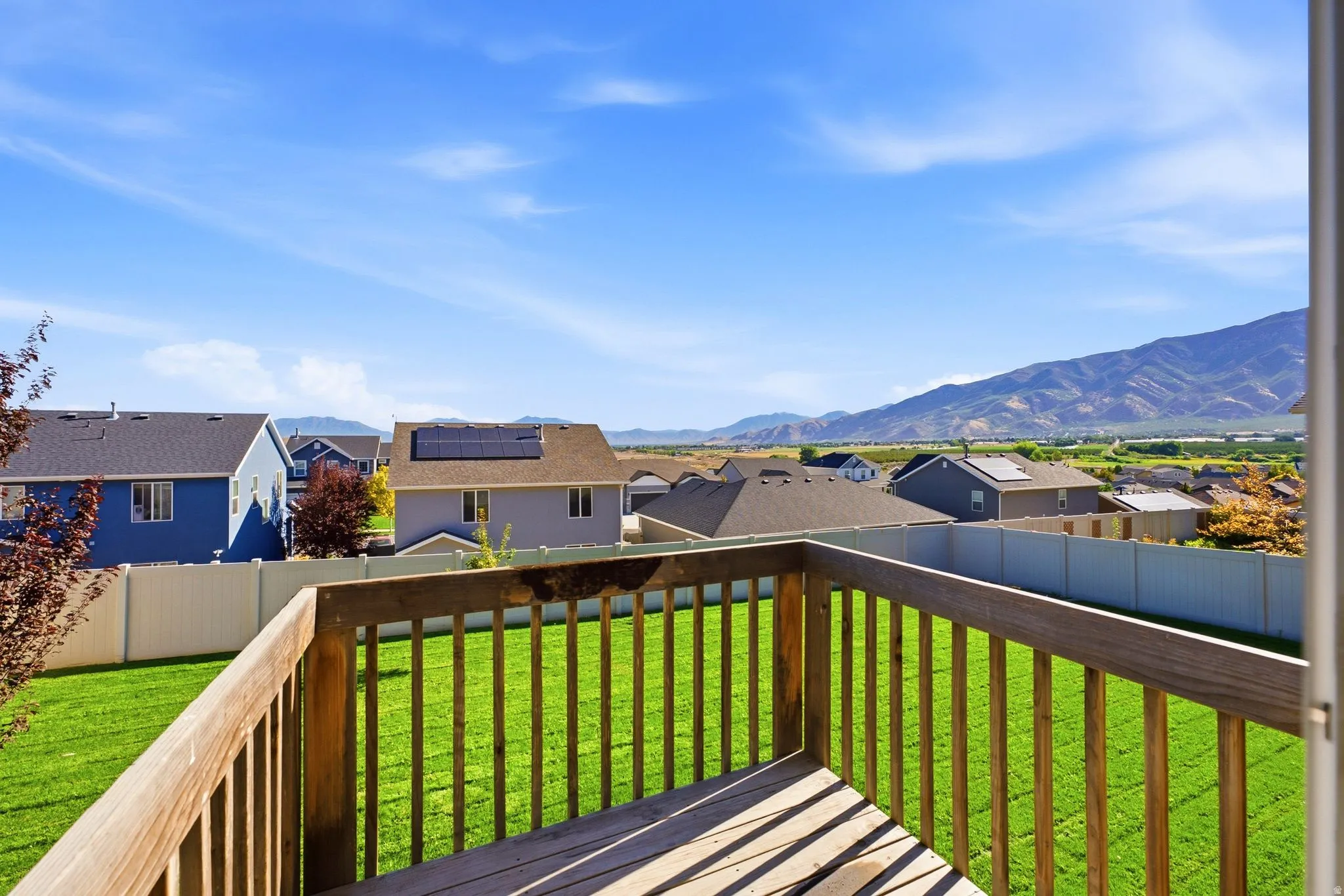 Wood deck with railing, providing an elevated outdoor living space