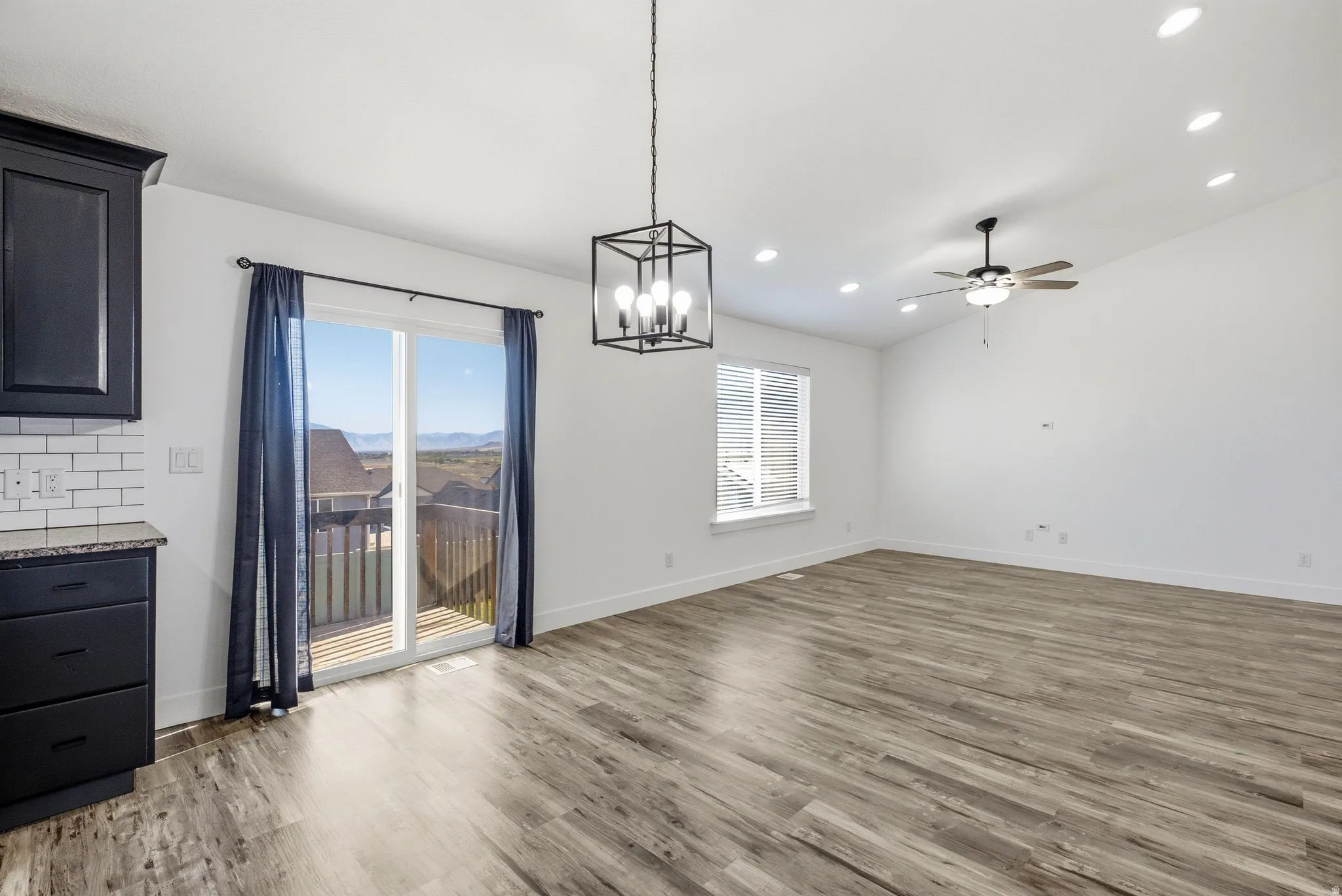 Wood-finish flooring throughout, with a ceiling fan and recessed lighting