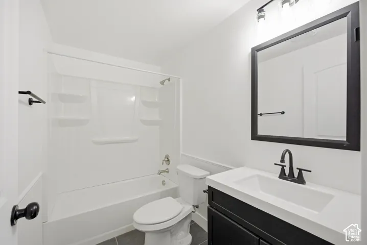 White vanity with integrated sink, black cabinet, black framed mirror, and black faucet