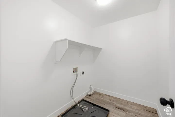 White walls, wood-finish flooring, and a built-in shelf