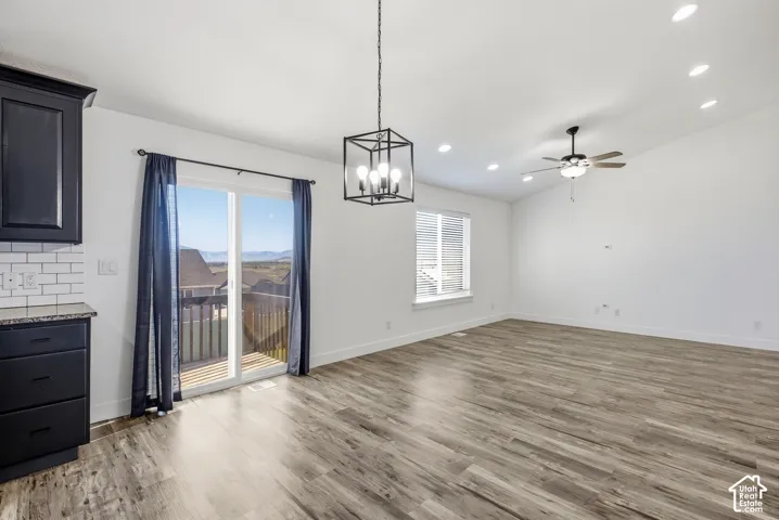 Wood-finish flooring throughout, with a ceiling fan and recessed lighting