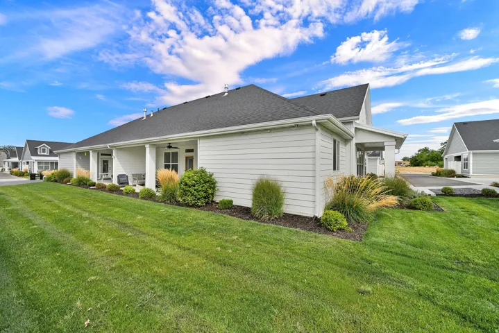 White horizontal siding exterior with a dark shingle roof