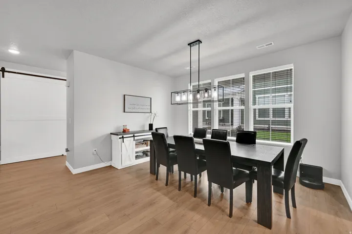 Warm wood-finish flooring complements the neutral wall tones