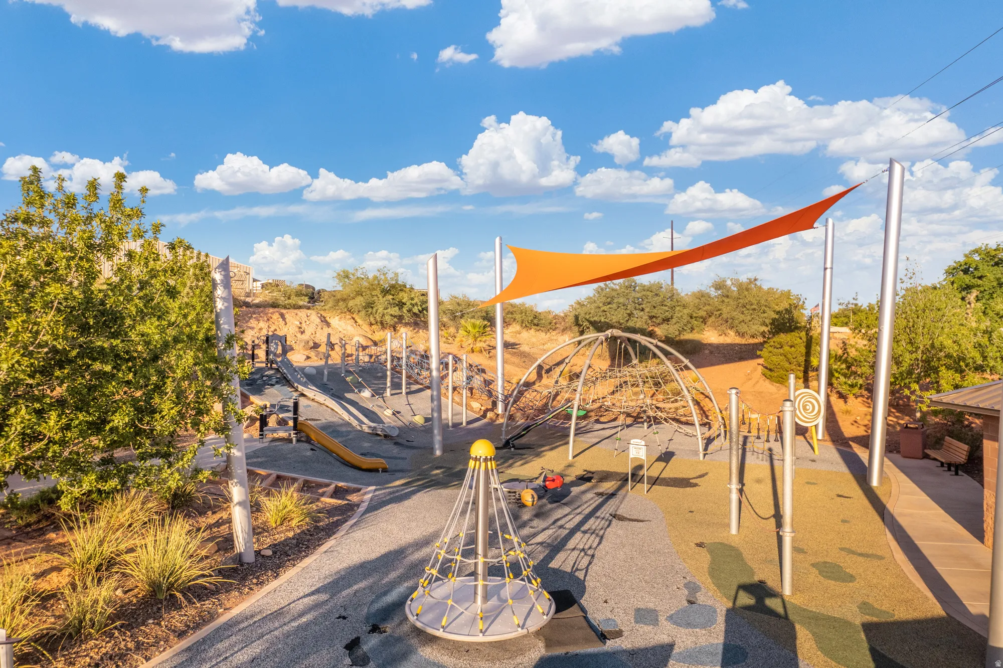 Community playground featuring slides, climbing structures, and shade sails