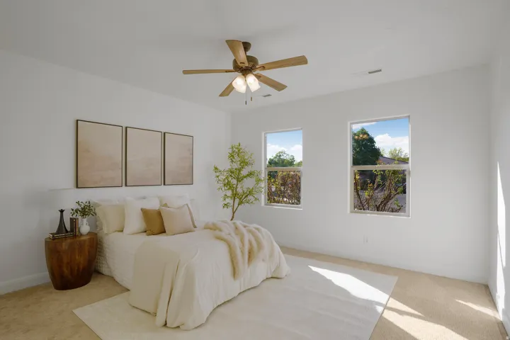 White wall finishes, recessed lighting, ceiling fan with light fixture, two windows, and carpeted flooring