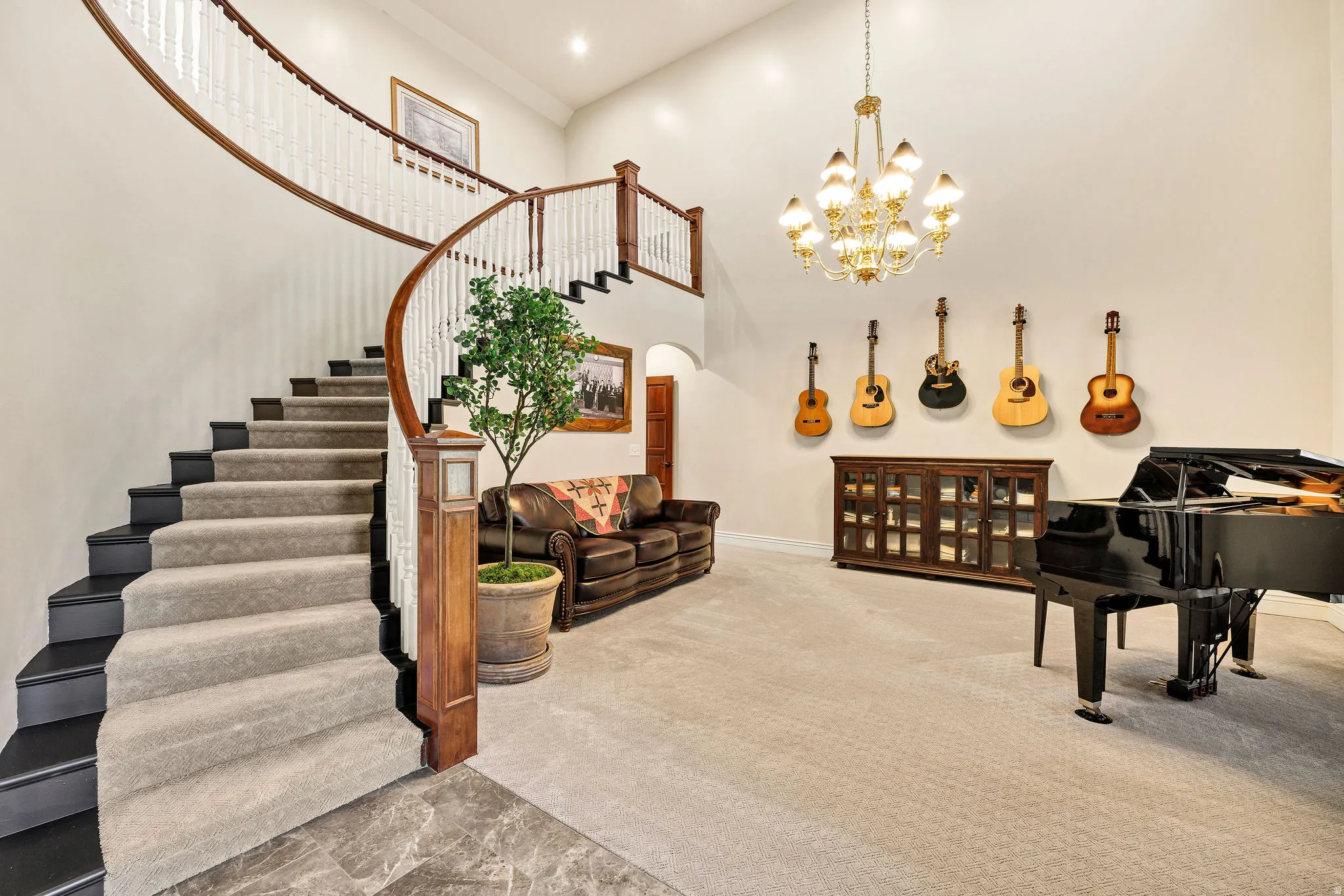 Grand entry featuring a curved staircase with wood banisters, white spindles, and carpeted treads
