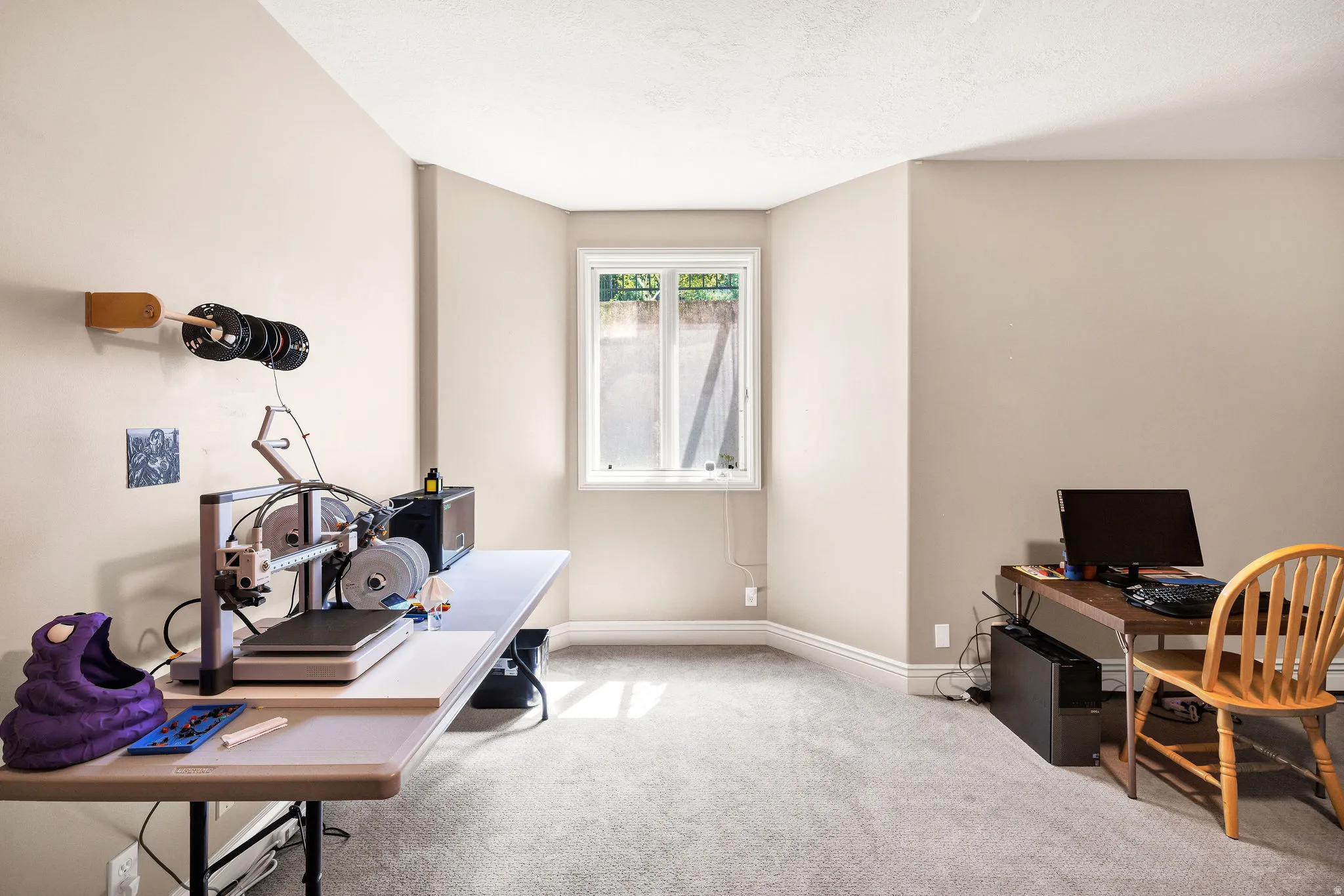 Neutral wall paint, window with natural light, and carpeted flooring