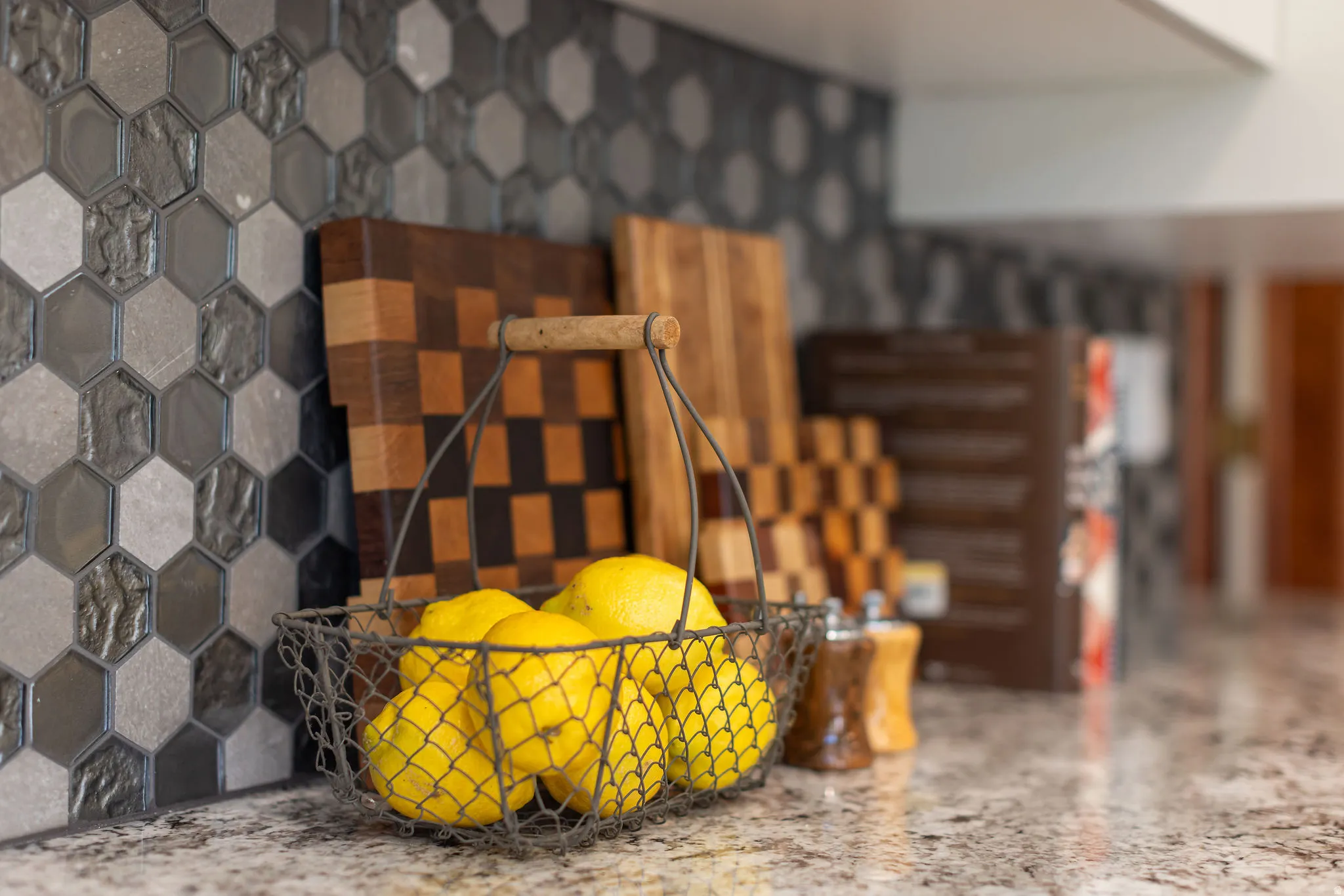 Granite-style countertop with hexagon tile backsplash