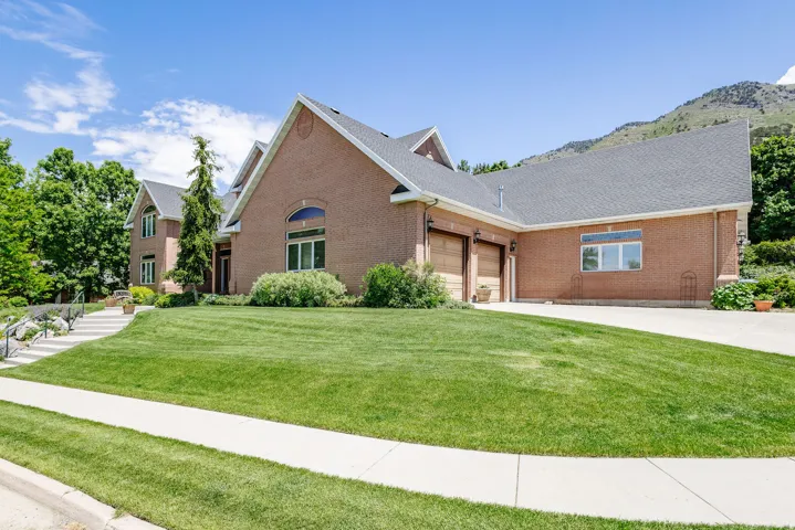 Brick exterior with multiple gables and a gray shingle roof