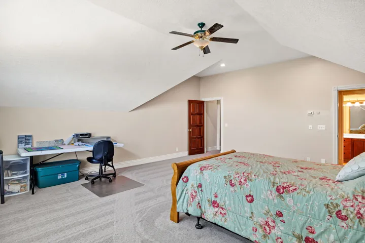 Vaulted ceilings with recessed lighting and a ceiling fan