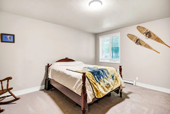 Carpeted room with a double-pane window featuring blinds