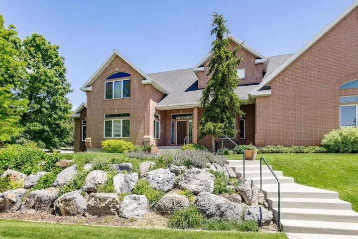 Brick exterior with multiple gables, arched windows, and a prominent entry