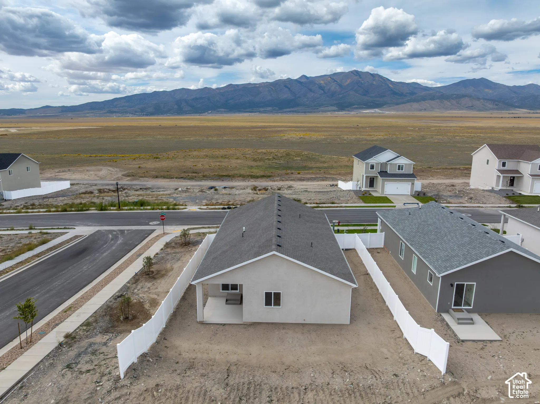 New construction residence featuring a neutral exterior, a private rear patio, and a shingled roof