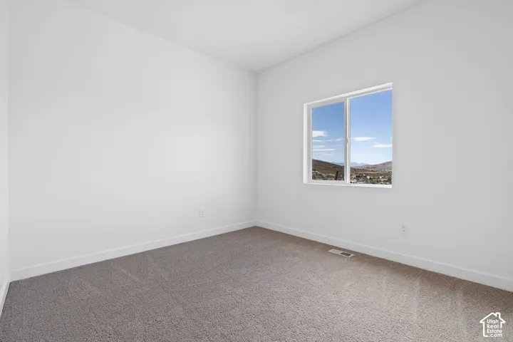 Rectangular window, gray carpeting, white walls, white trim