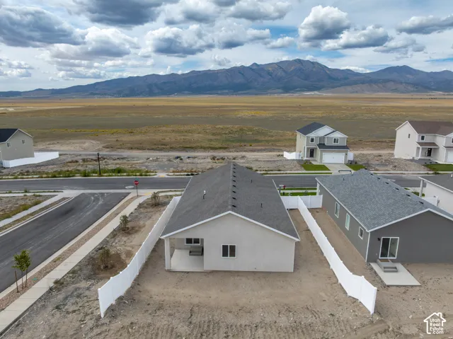 New construction residence featuring a neutral exterior, a private rear patio, and a shingled roof
