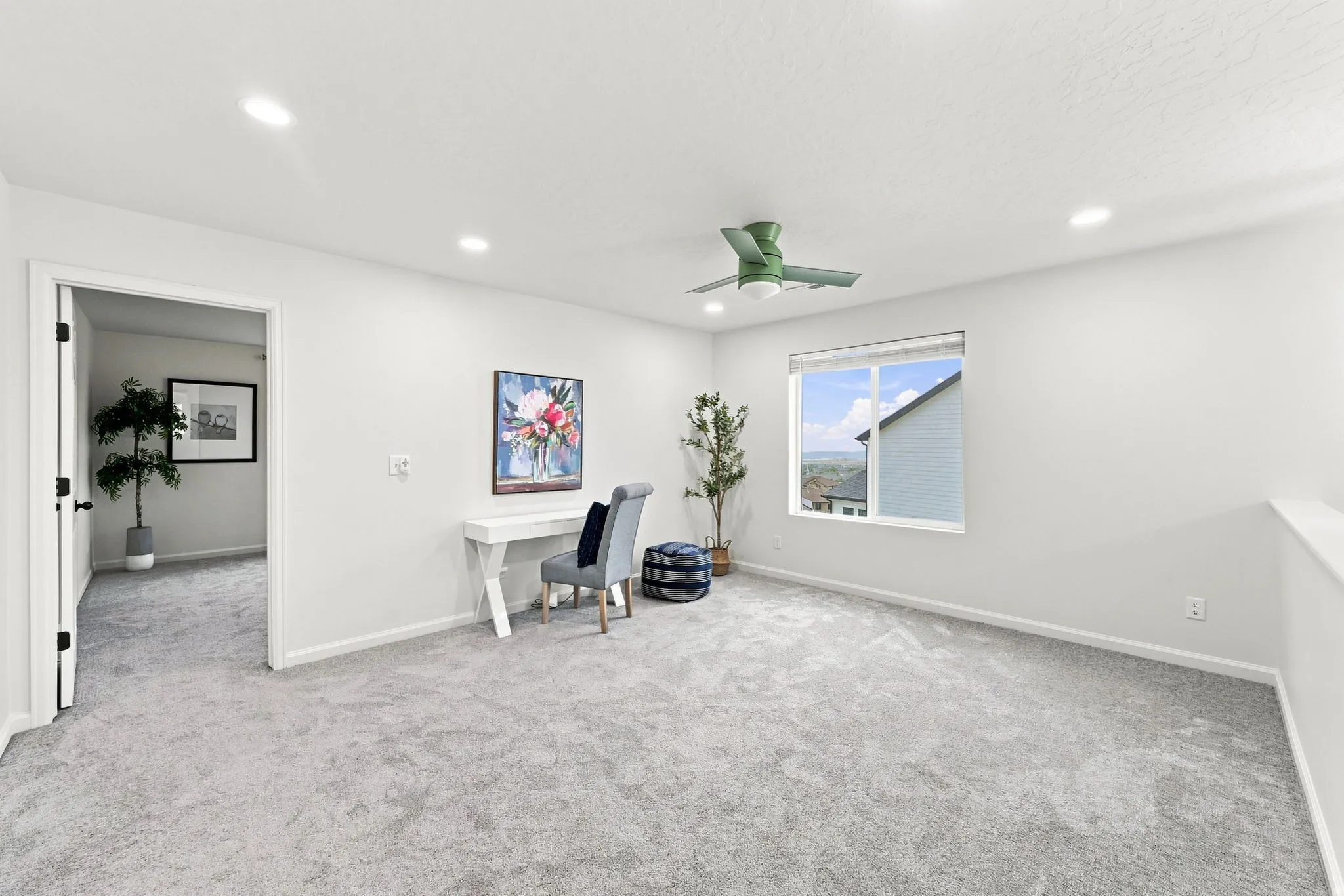 Recessed lighting, light gray carpeting, ceiling fan, and a large window