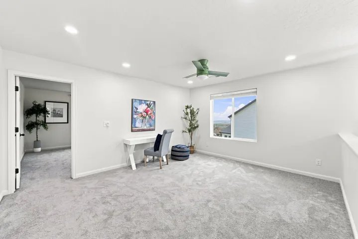 Recessed lighting, light gray carpeting, ceiling fan, and a large window