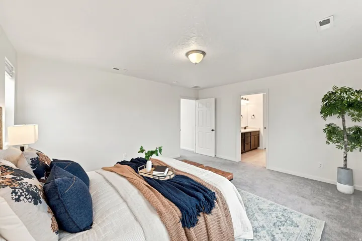 Spacious room featuring light gray carpeting and white walls