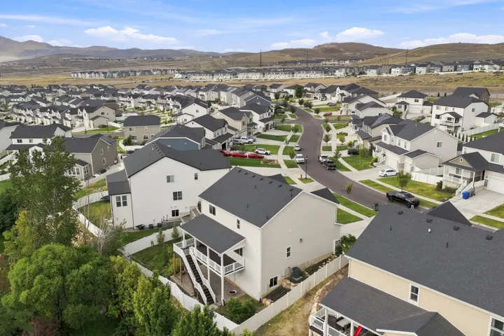 Residential neighborhood with varied rooflines and a mountainous backdrop
