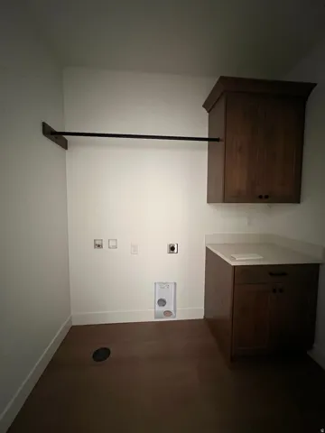Wood-finish flooring with white baseboards