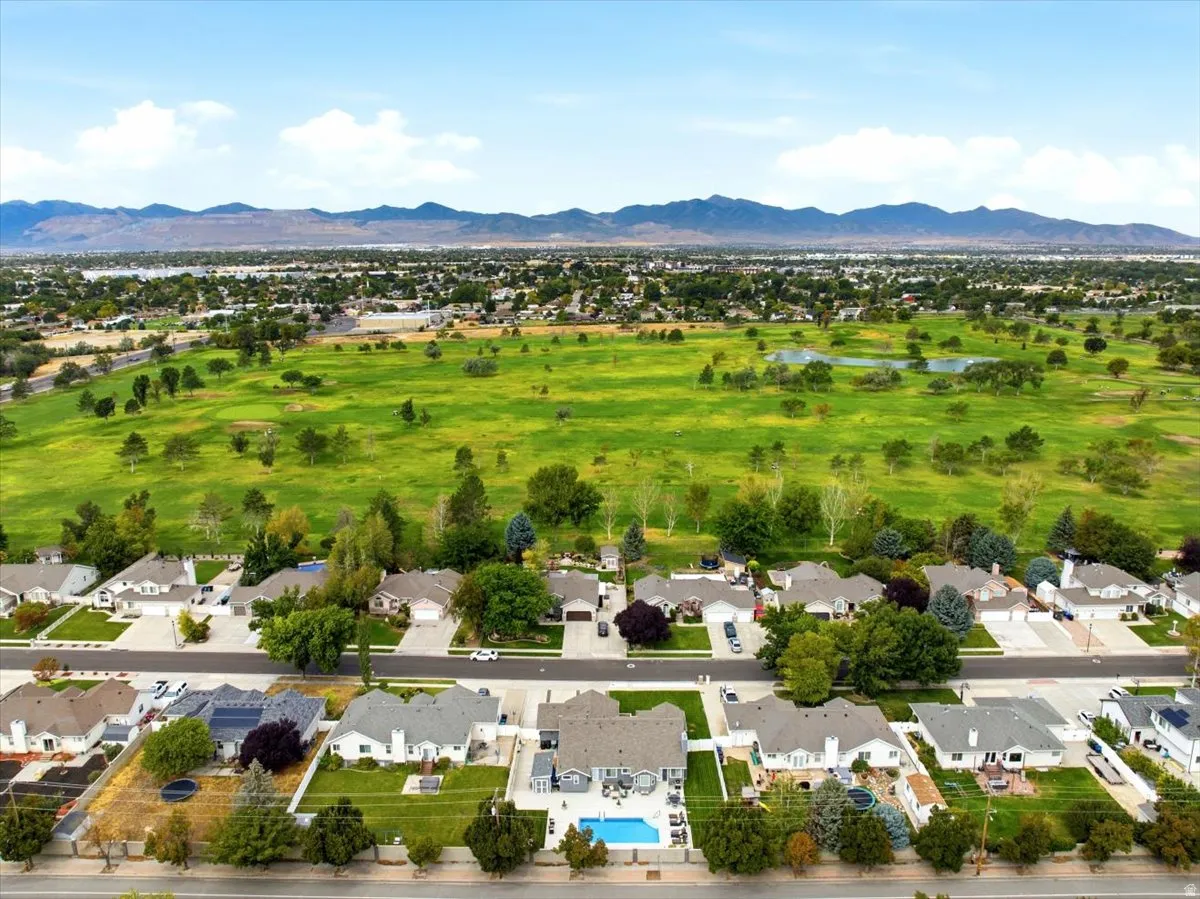Expansive green space and mountain backdrop