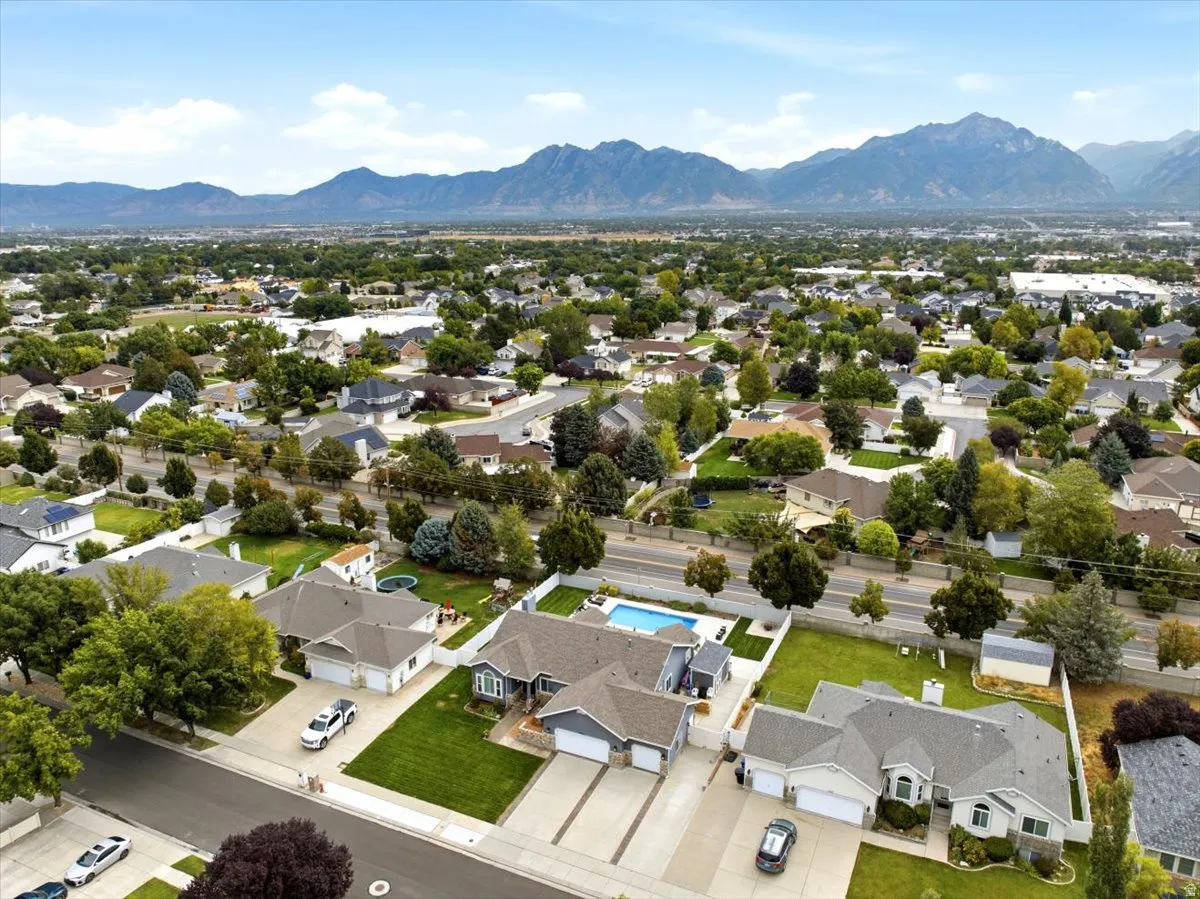Aerial perspective showcasing an expansive residential area with surrounding mountain ranges