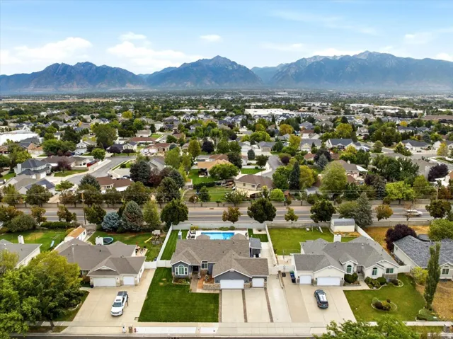 Mountain range backdrop over a residential neighborhood with mature trees
