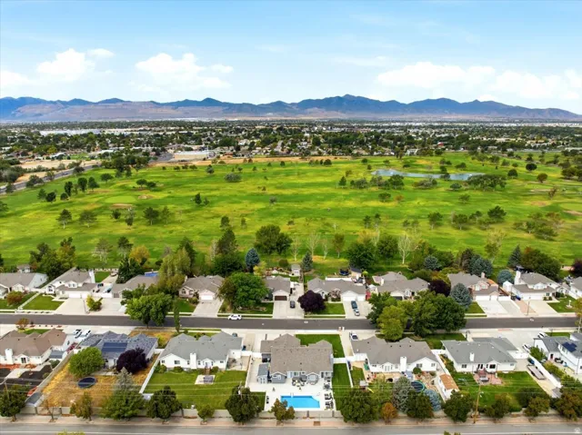 Expansive green space and mountain backdrop