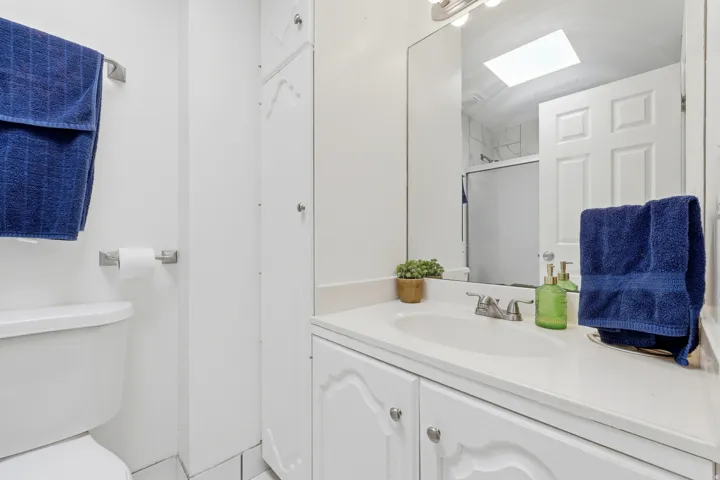 White vanity with an integrated sink and chrome fixtures