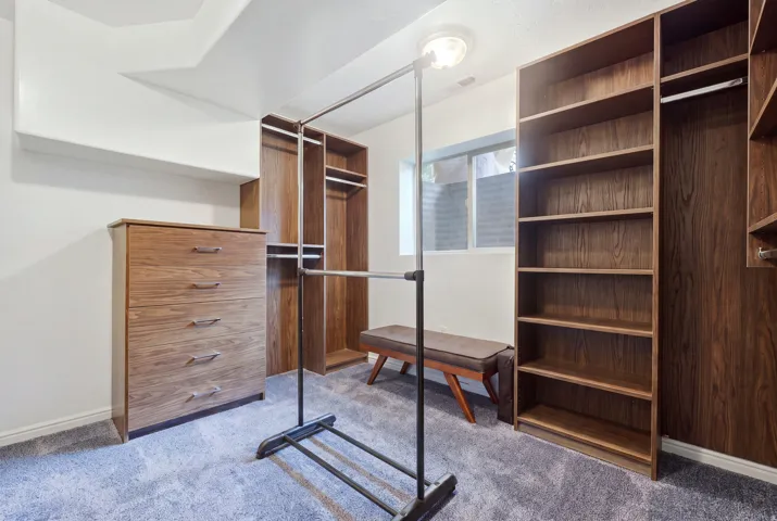 Built-in custom cabinetry with wood-finish shelving and hanging rods