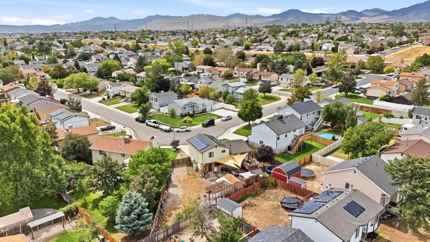 Expansive residential area featuring established homes, mature landscaping, and mountain backdrops