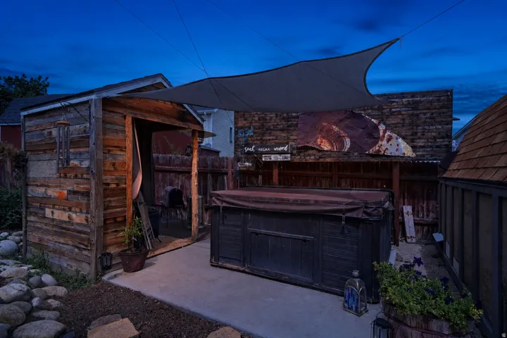 Hardscaping with a concrete pad, a freestanding storage shed, and a privacy fence