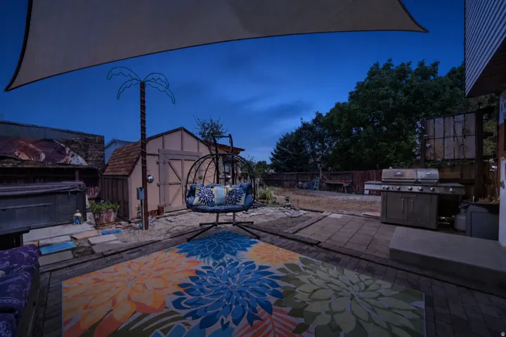 Backyard featuring a shed, a privacy fence, and a shade sail