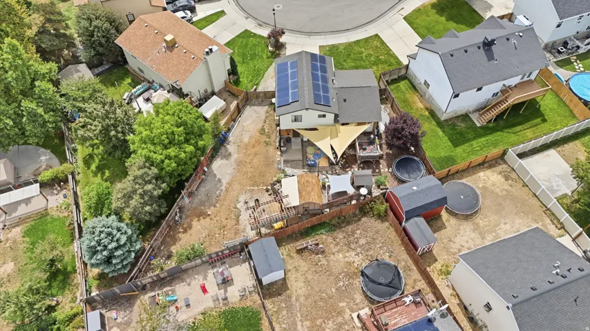 Two-story residence with solar panels and a multi-level deck