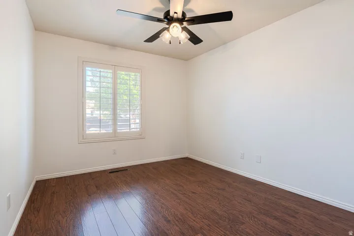 Wood-finish flooring with white baseboards