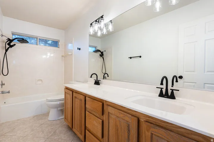 Dual sink vanity with wood-finish cabinetry and white countertop