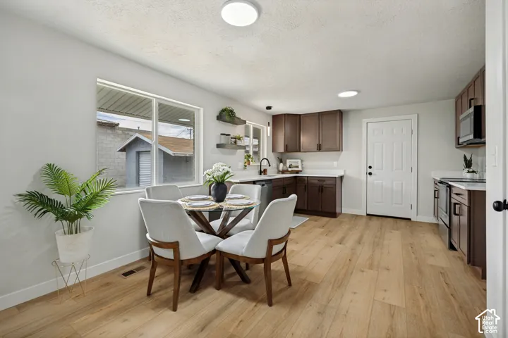 Wood-finish flooring, white walls, recessed lighting, white trim, and a window with a white frame