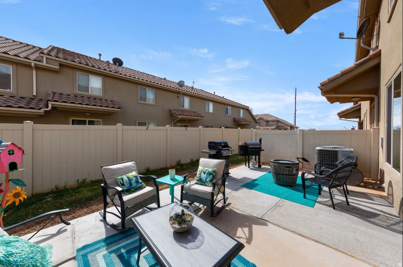Concrete patio with perimeter fencing and stucco exterior