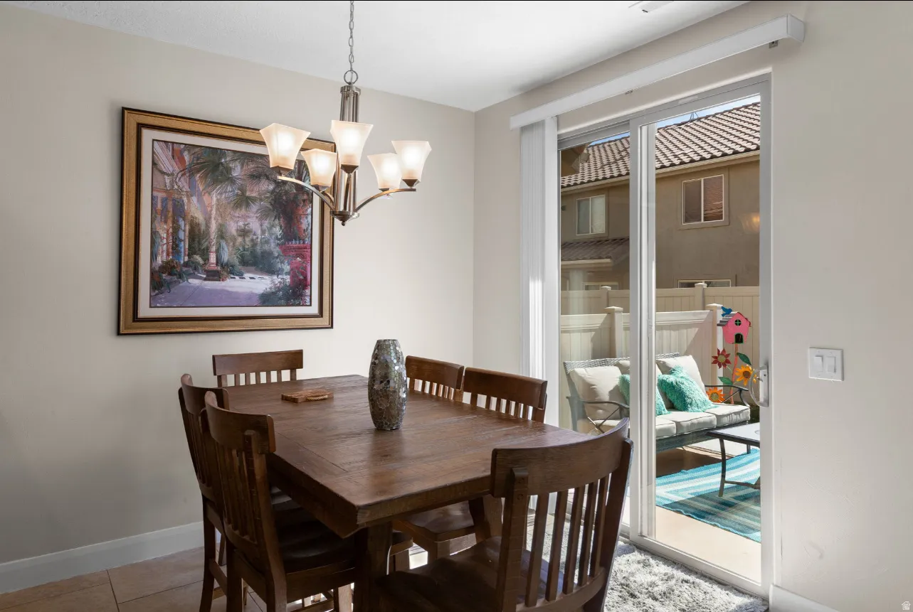 Sliding glass door leading to an outdoor patio with privacy fencing