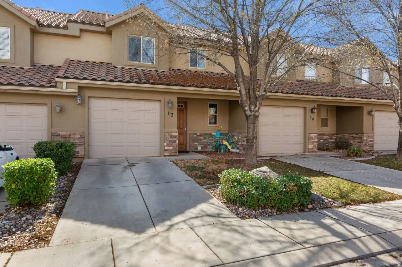 Stucco exterior with stone accents and a terracotta tile roof