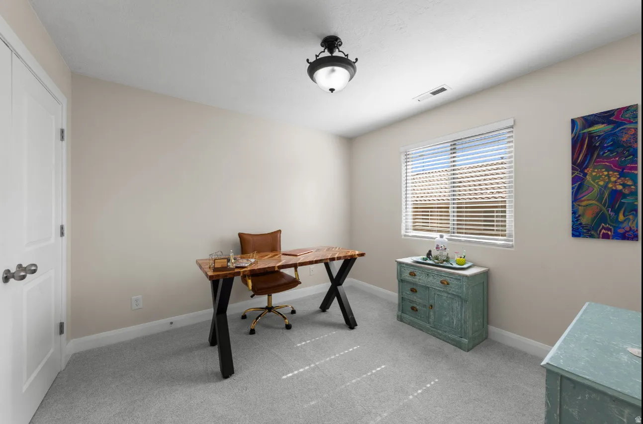 Recessed lighting, light gray carpeting, and a window with blinds