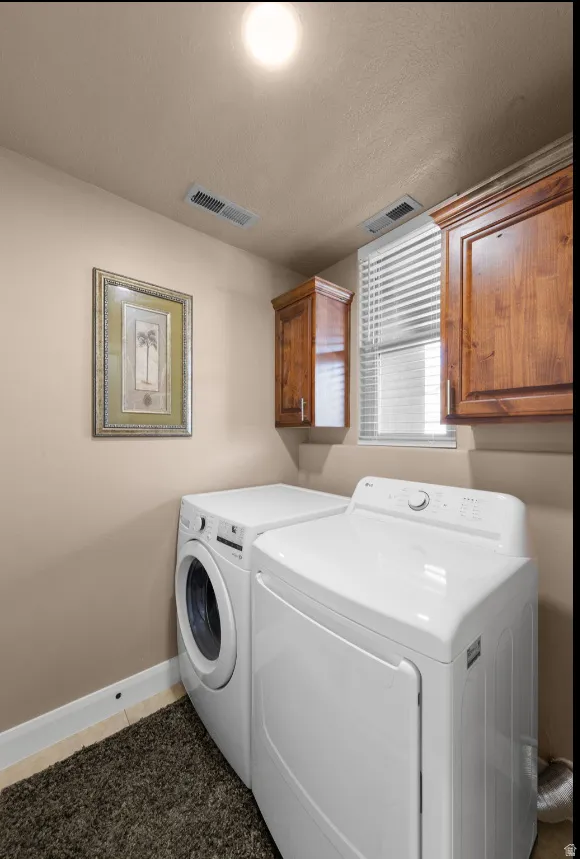 Integrated laundry area featuring wood-finish cabinetry, a window with blinds, and recessed lighting