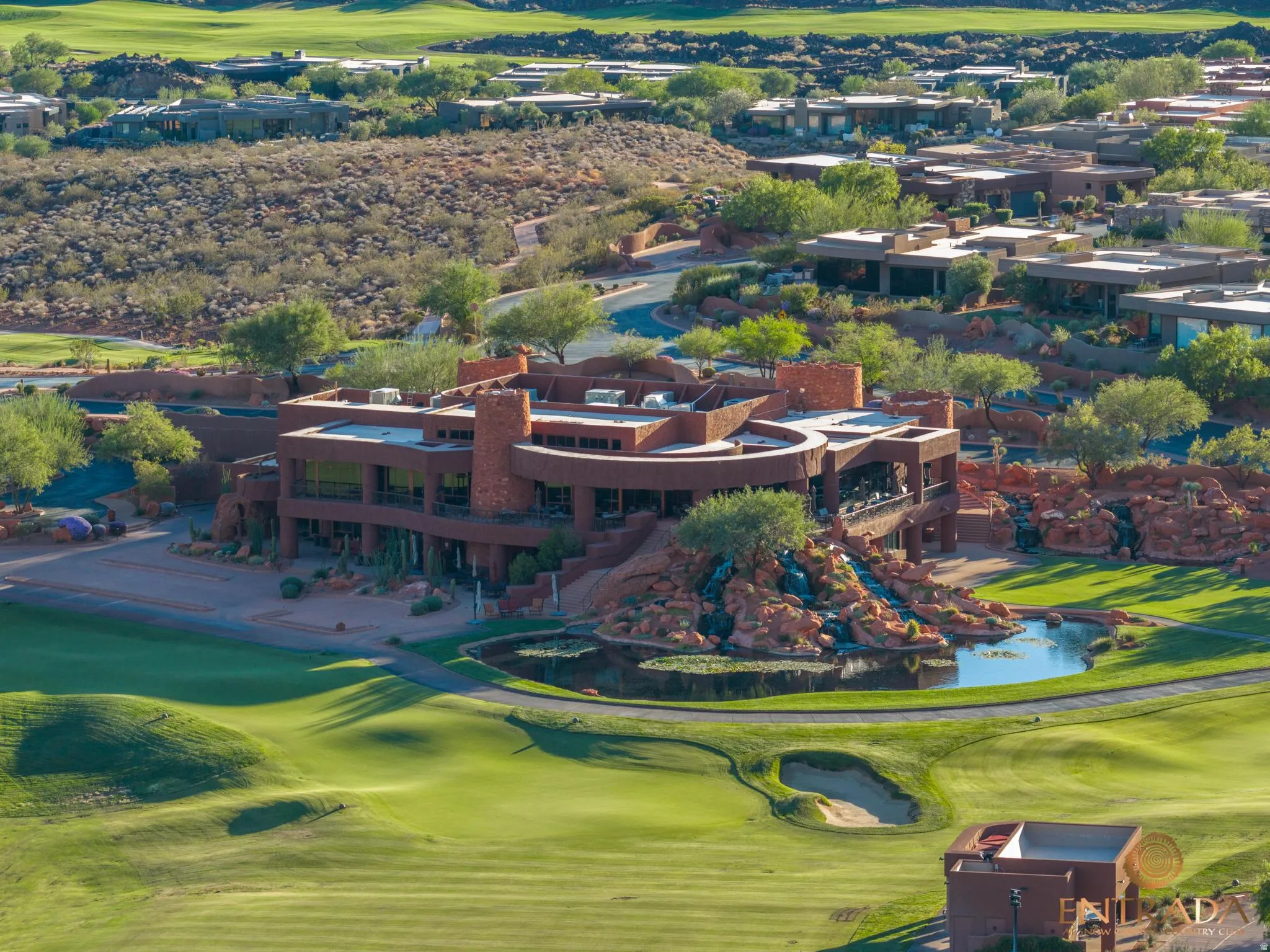 Golf course property featuring a large pond and rock waterfall landscaping. This is the clubhouse and Restaurant